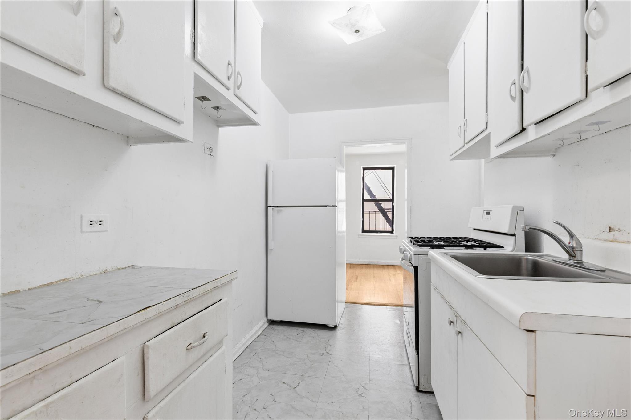 123-35 82nd Road, Unit 3N Queens, NY 11415 - Photo 5 of 10 Large windowed kitchen leads to dining area