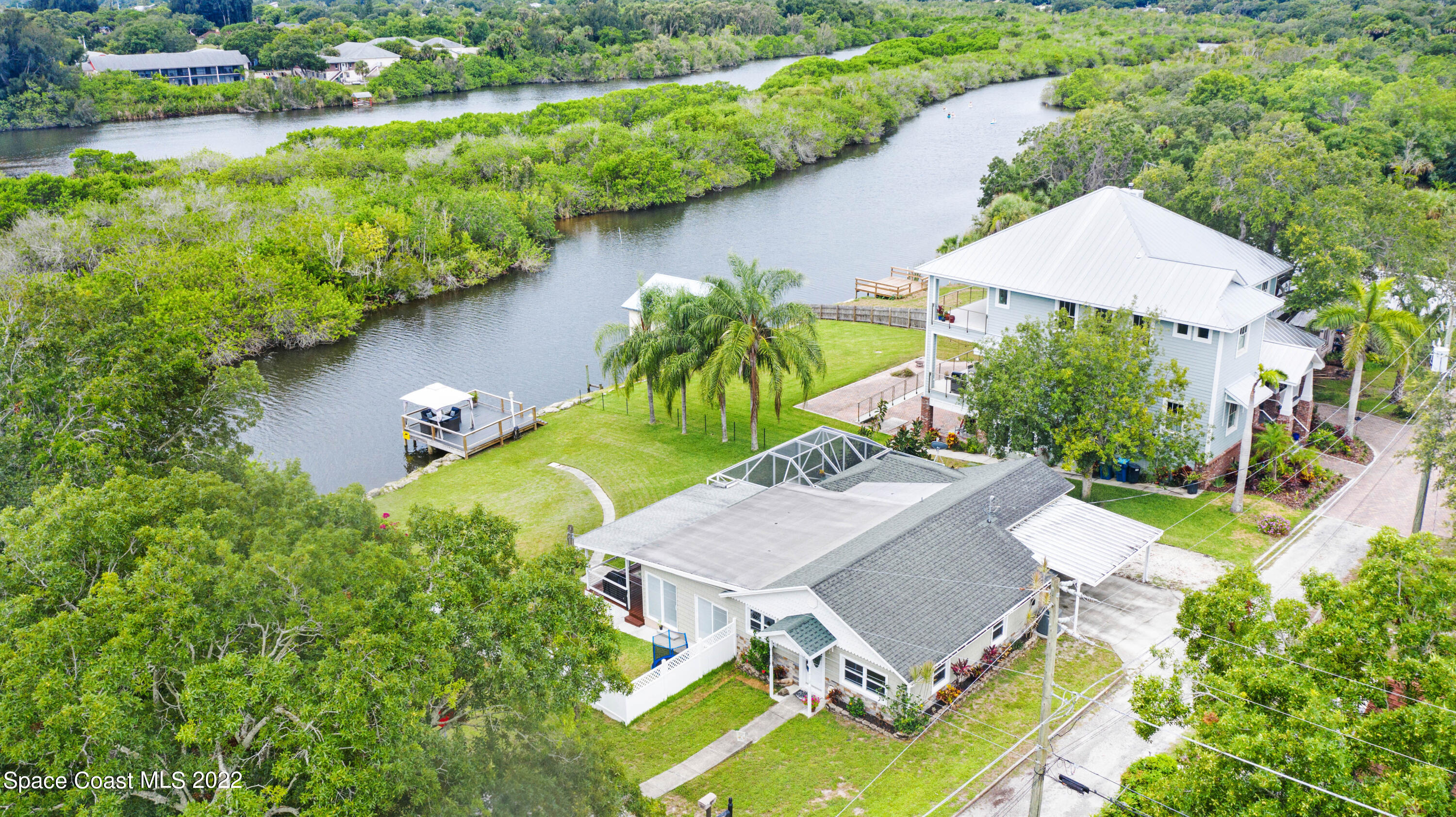 1304 Lichty Street Palm Bay, FL 32905 - Photo 1 of 57 an aerial view of a house with outdoor space and lake view