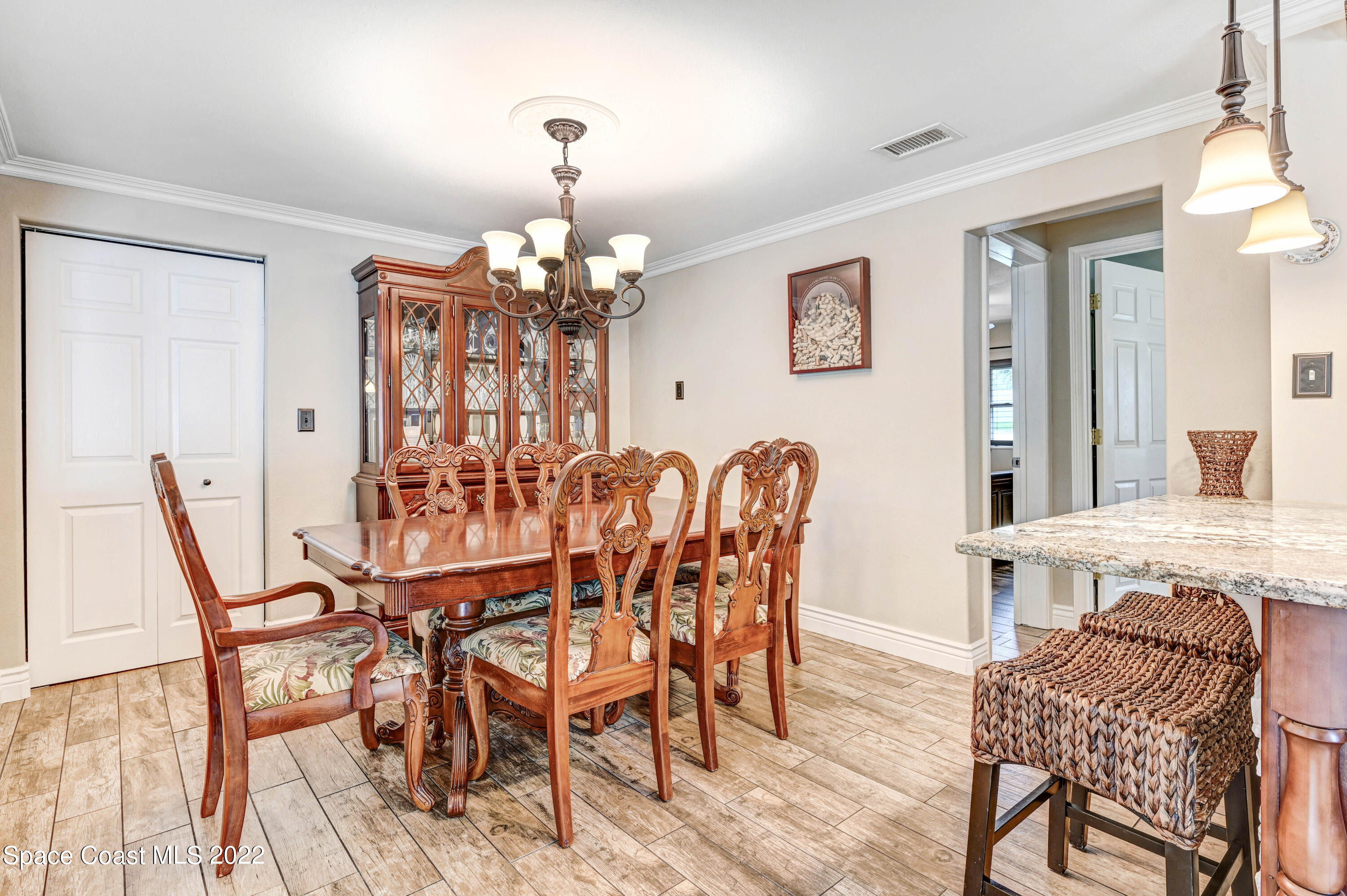 1304 Lichty Street Palm Bay, FL 32905 - Photo 11 of 57 a view of a dining room with furniture and wooden floor