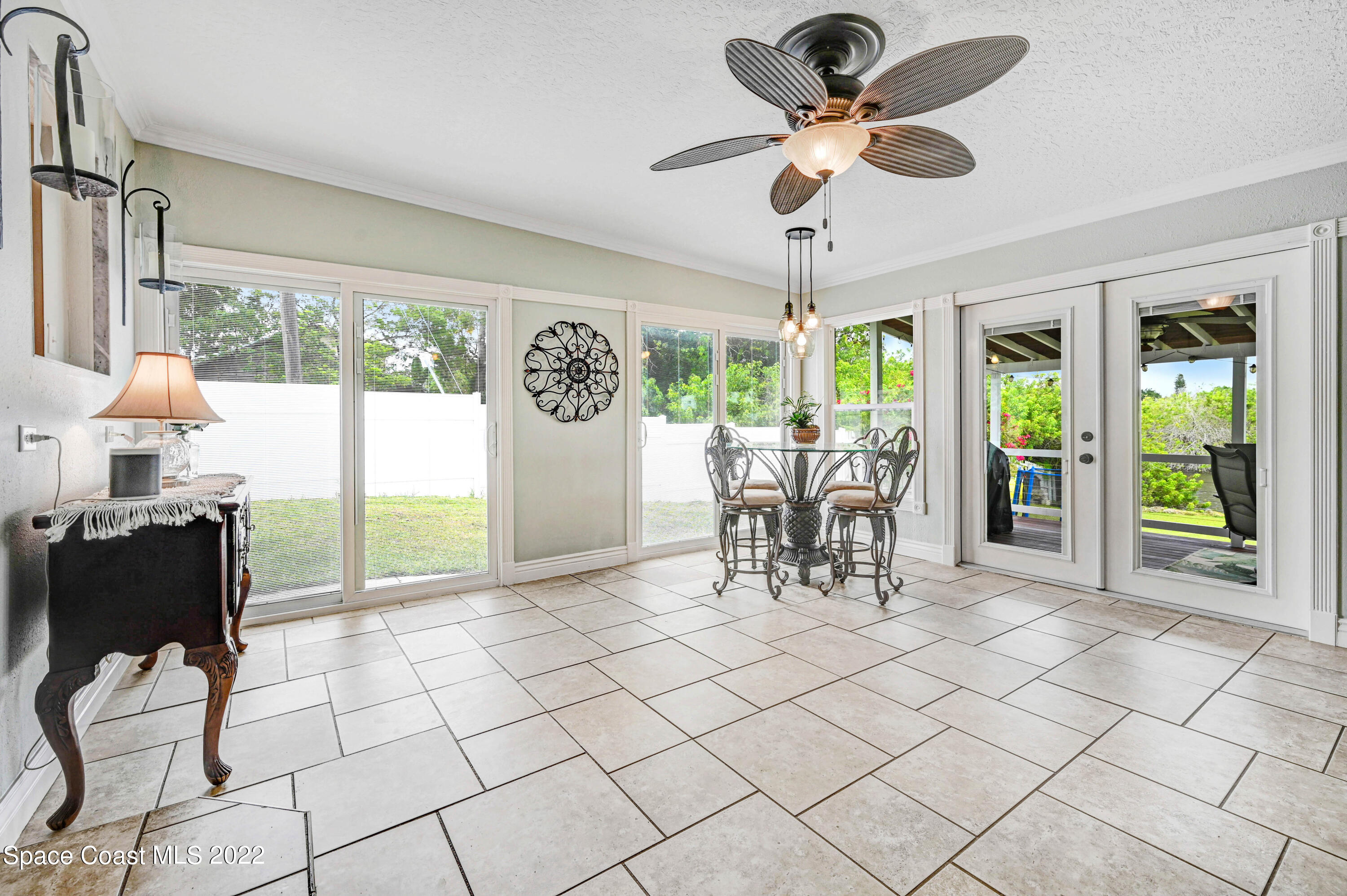 1304 Lichty Street Palm Bay, FL 32905 - Photo 15 of 57 a living room with a floor to ceiling windows and a dining table