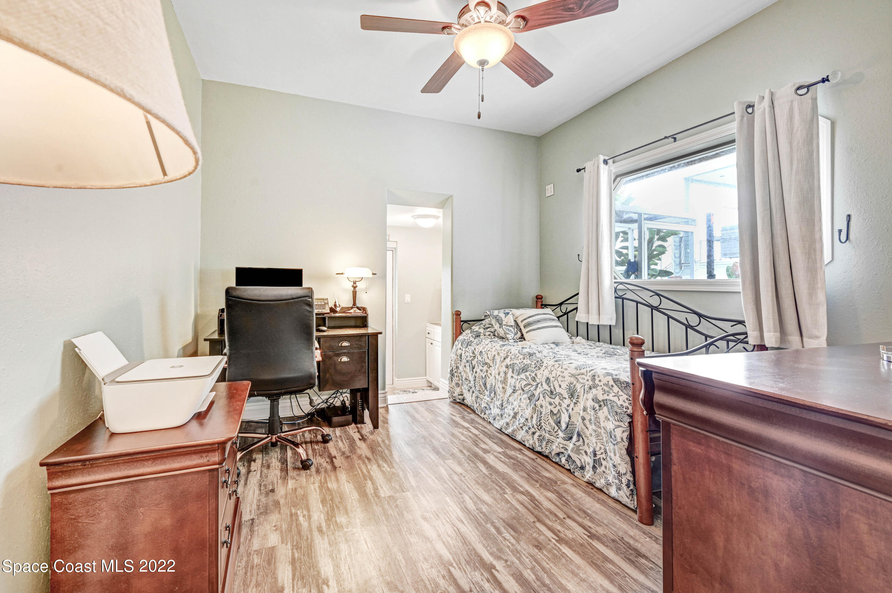 1304 Lichty Street Palm Bay, FL 32905 - Photo 21 of 57 a bedroom with a bed and a chair