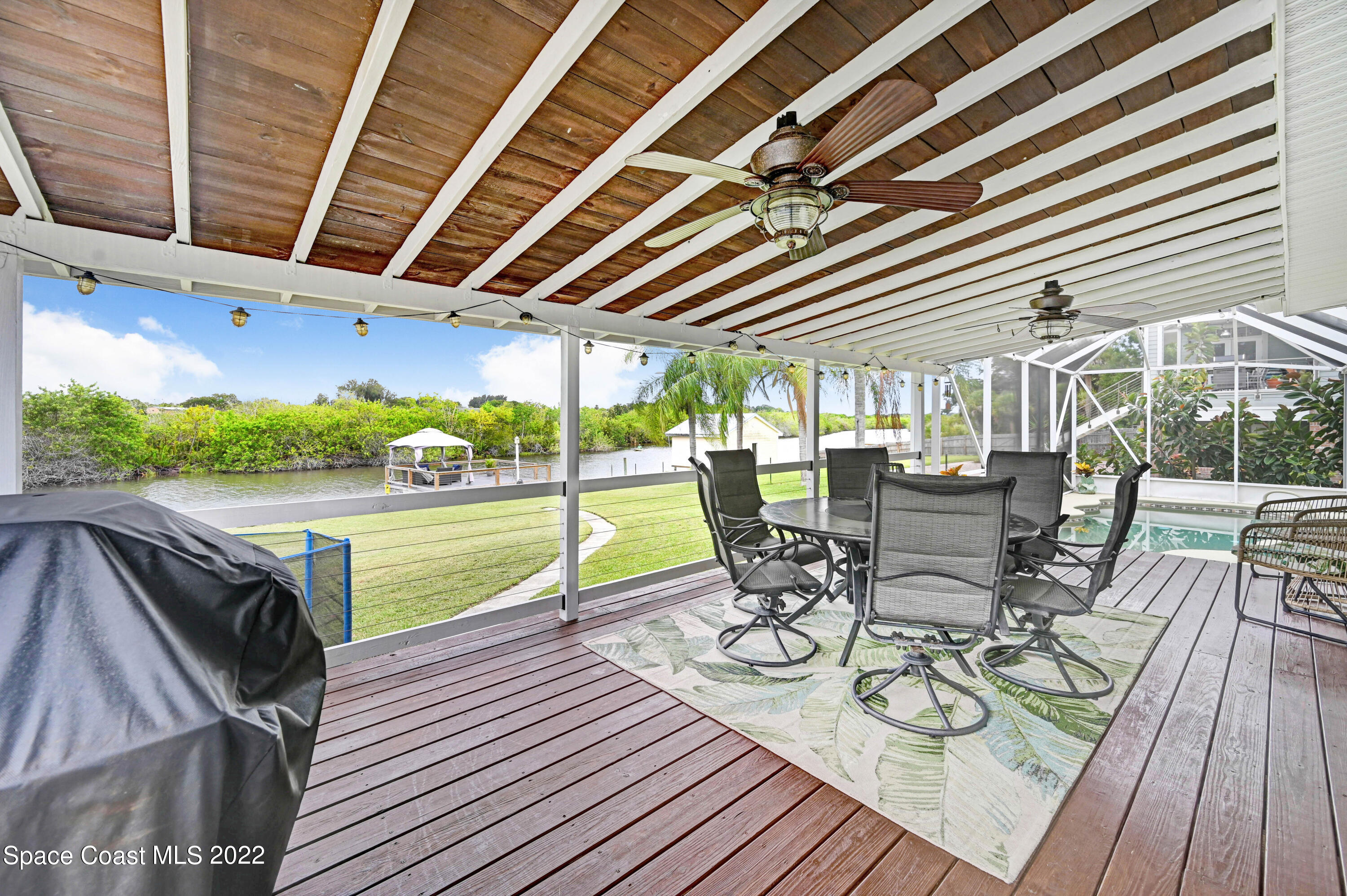 1304 Lichty Street Palm Bay, FL 32905 - Photo 30 of 57 a view of a swimming pool with a table and chairs