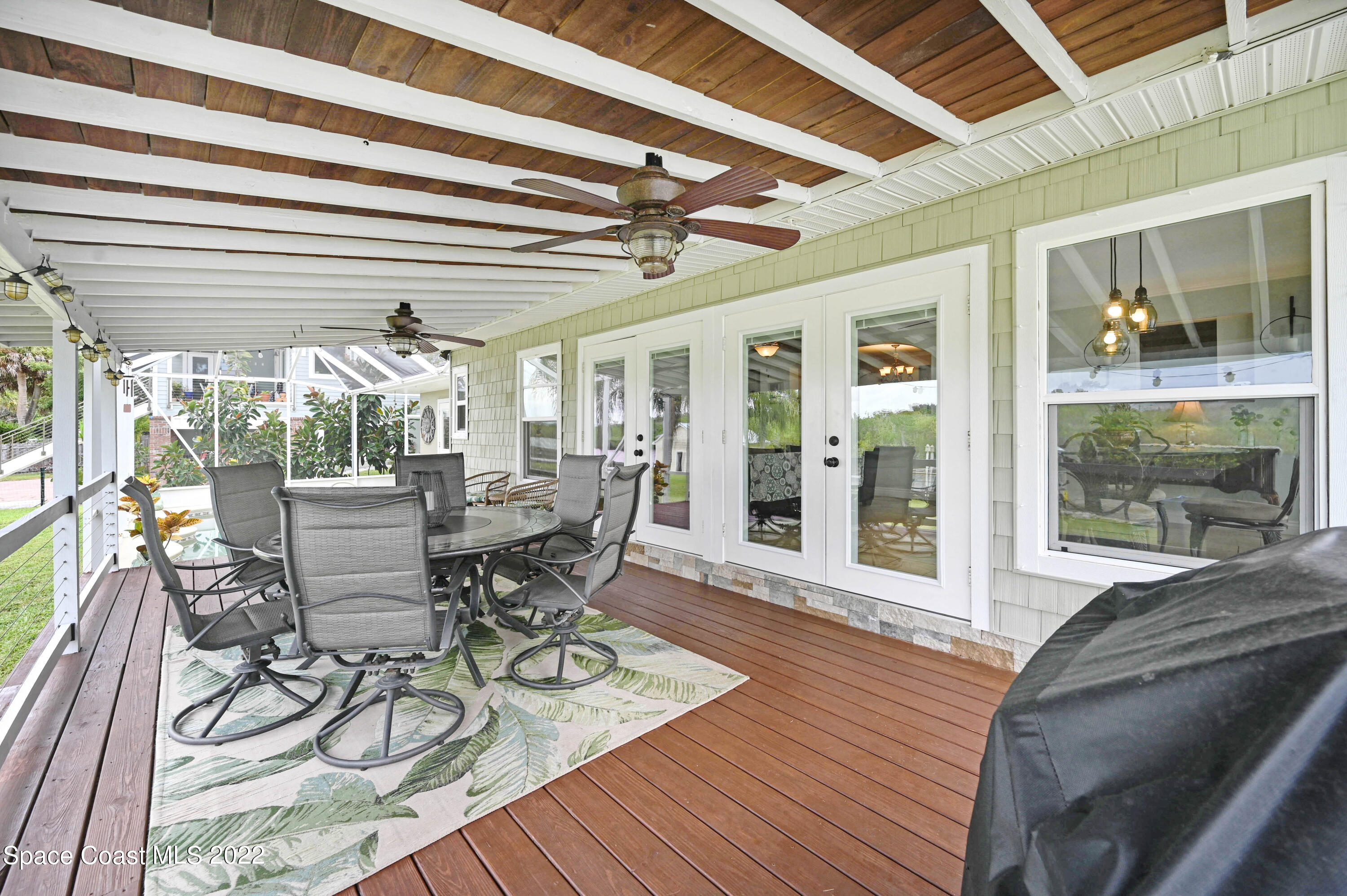 1304 Lichty Street Palm Bay, FL 32905 - Photo 32 of 57 a view of a dining room with furniture wooden floor and a chandelier