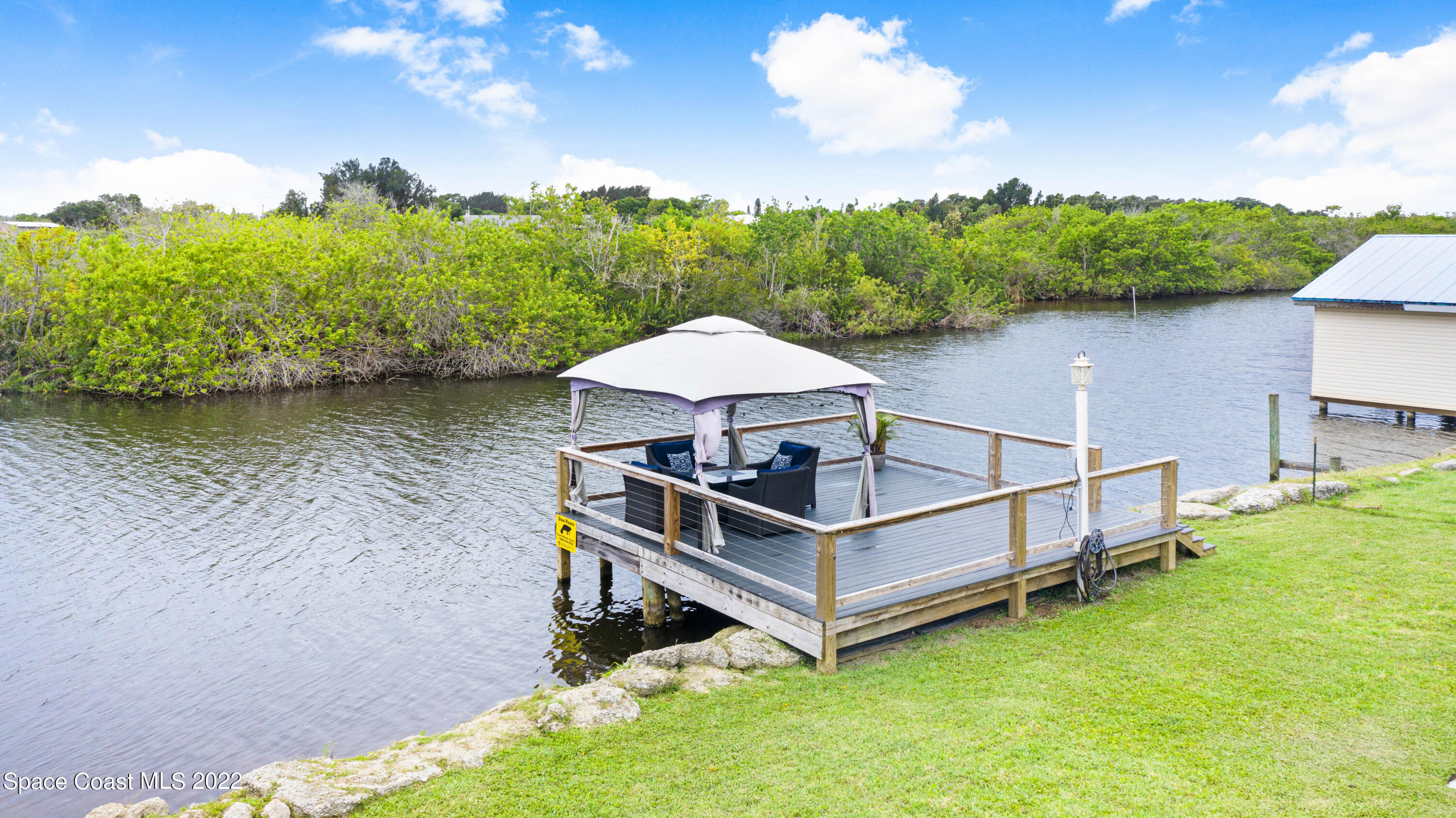1304 Lichty Street Palm Bay, FL 32905 - Photo 35 of 57 a view of a house with a yard from a lake view