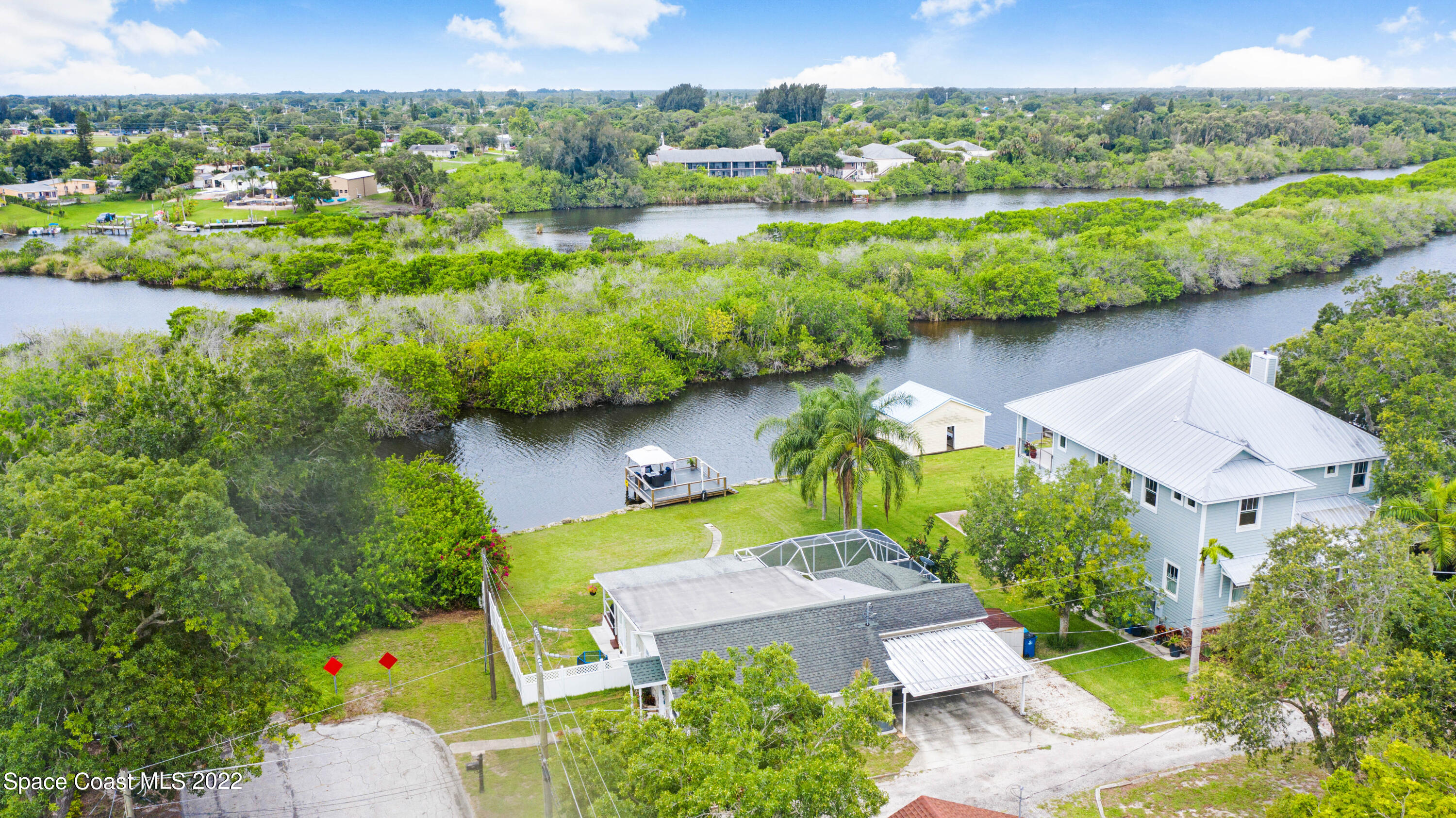 1304 Lichty Street Palm Bay, FL 32905 - Photo 44 of 57 an aerial view of a house with a garden and lake view