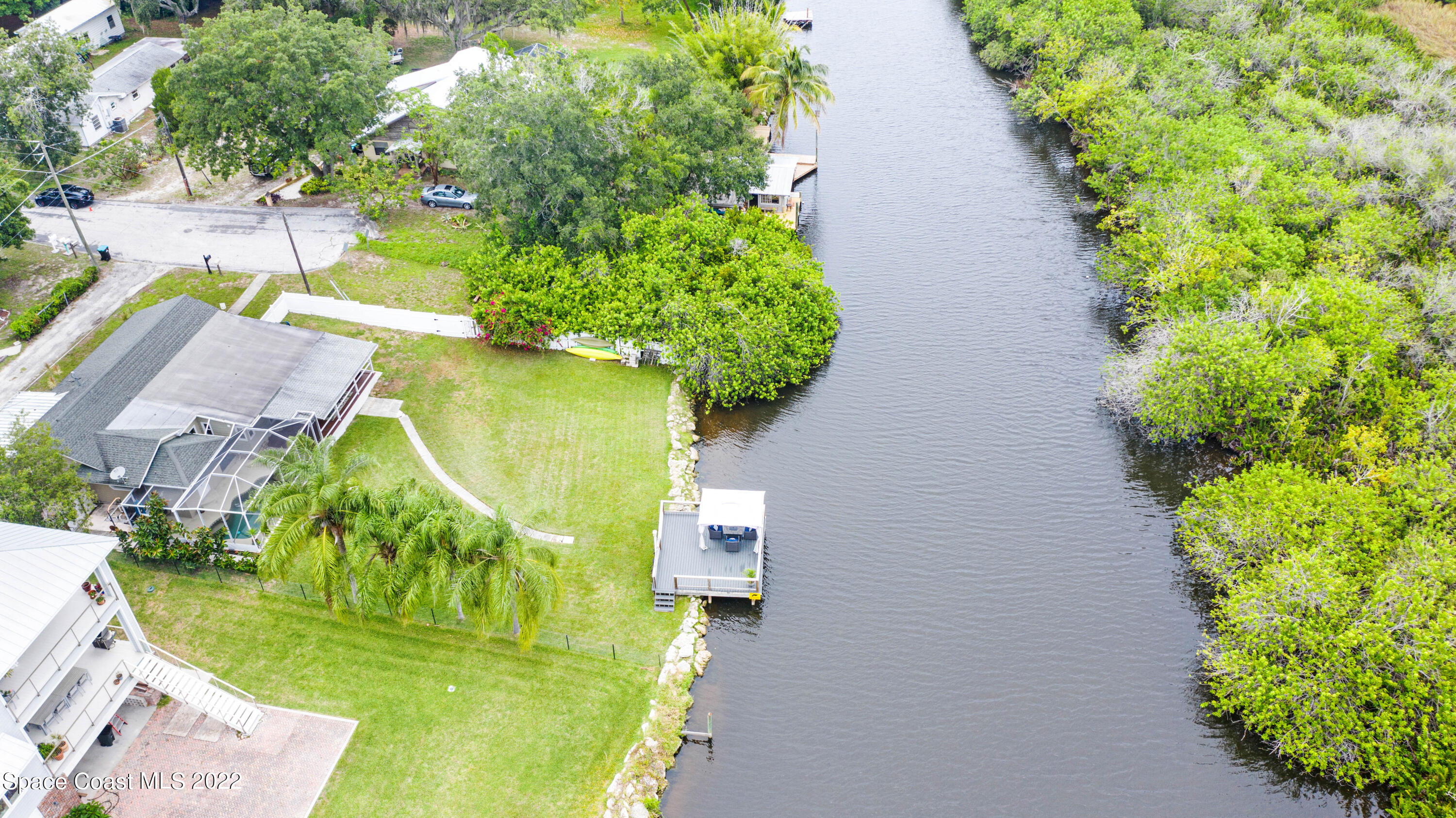 1304 Lichty Street Palm Bay, FL 32905 - Photo 48 of 57 an aerial view of a house with a yard swimming pool and lake view
