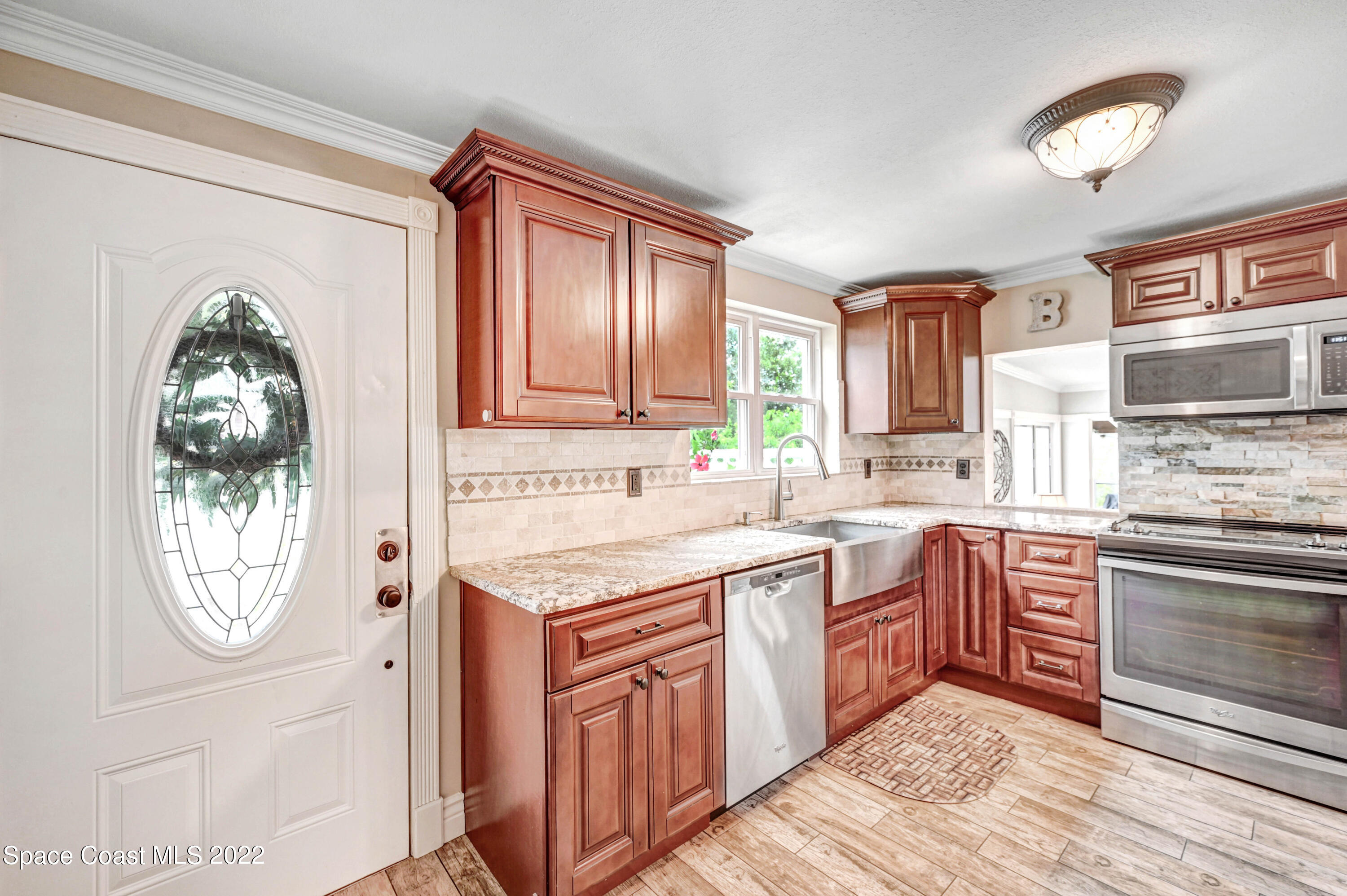 1304 Lichty Street Palm Bay, FL 32905 - Photo 10 of 57 a kitchen with stainless steel appliances granite countertop a stove and a sink