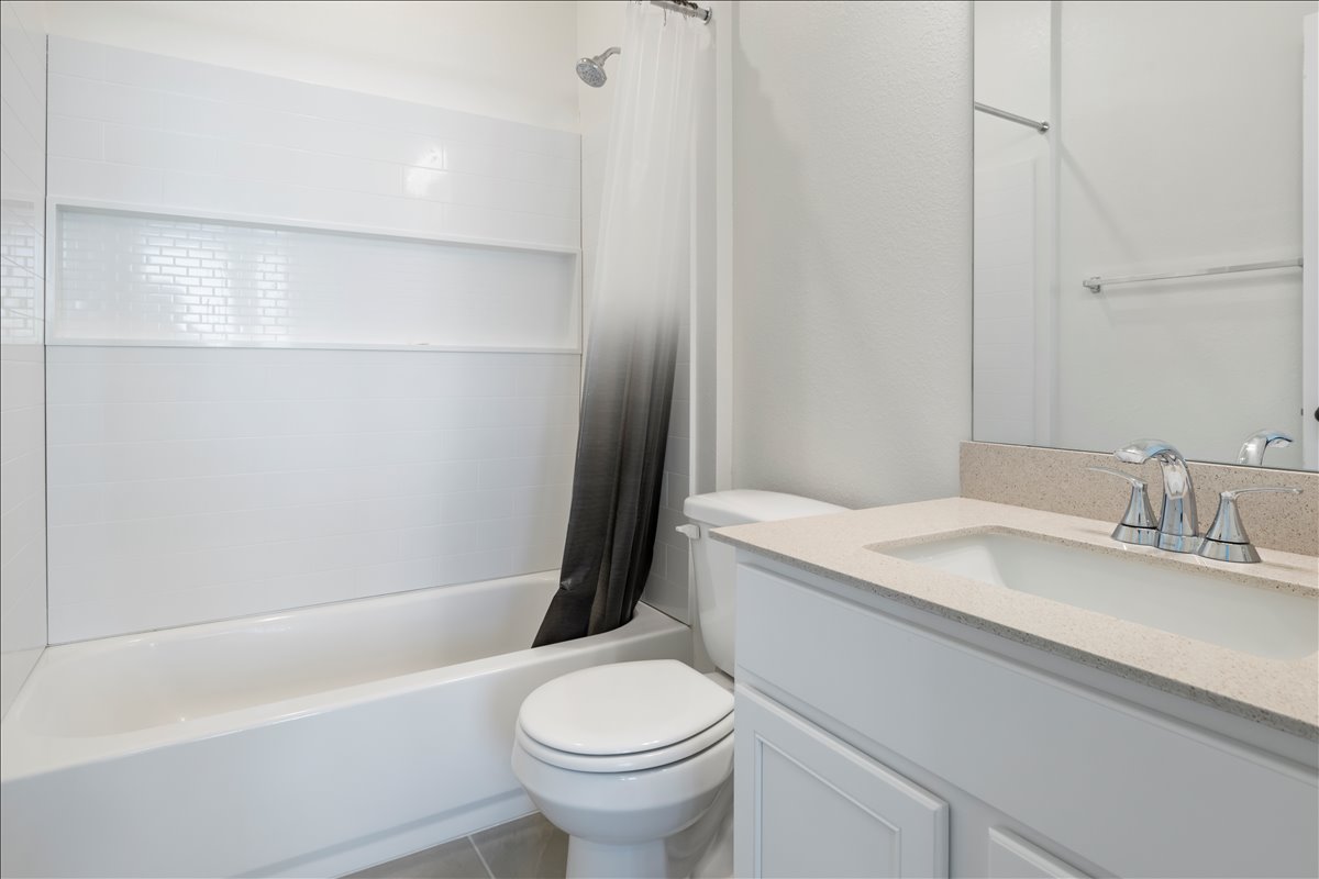 18501 Spotted Eagle Lane Elgin, TX 78621 - Photo 39 of 40 A well-appointed bathroom with contemporary fixtures and a sleek vanity.