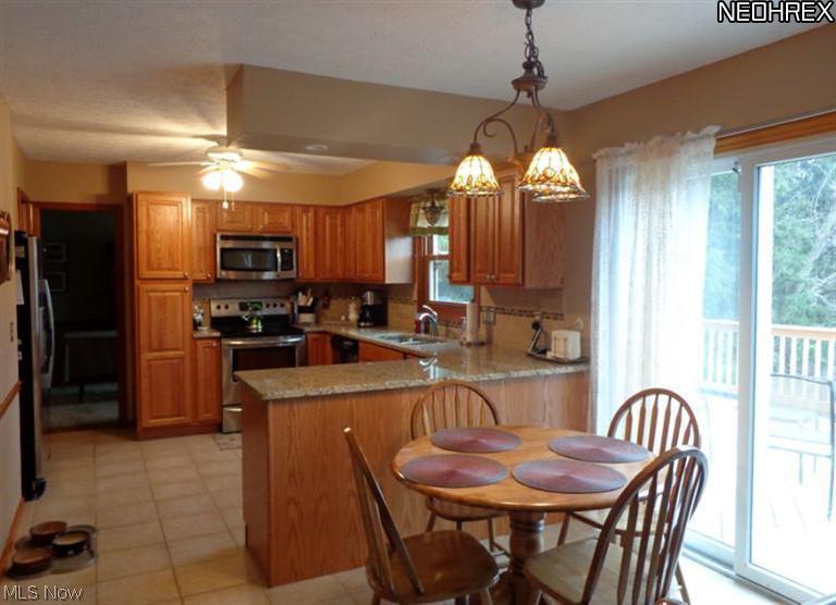 1530 Saxe Road Mogadore, OH 44260 - Photo 25 of 25 The open kitchen floor plan with updated lighting, granite countertops, newer stainless appliances