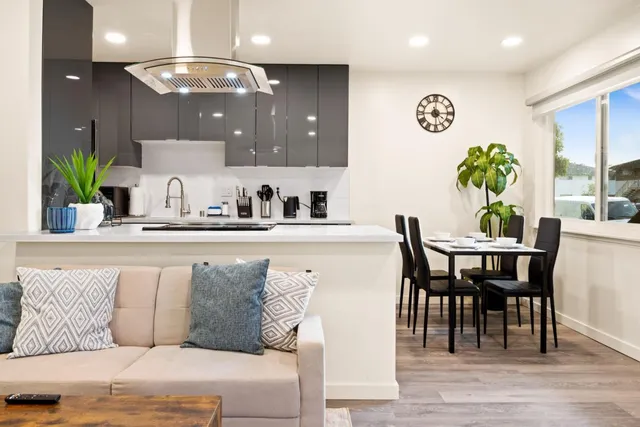 a dining room with furniture and wooden floor