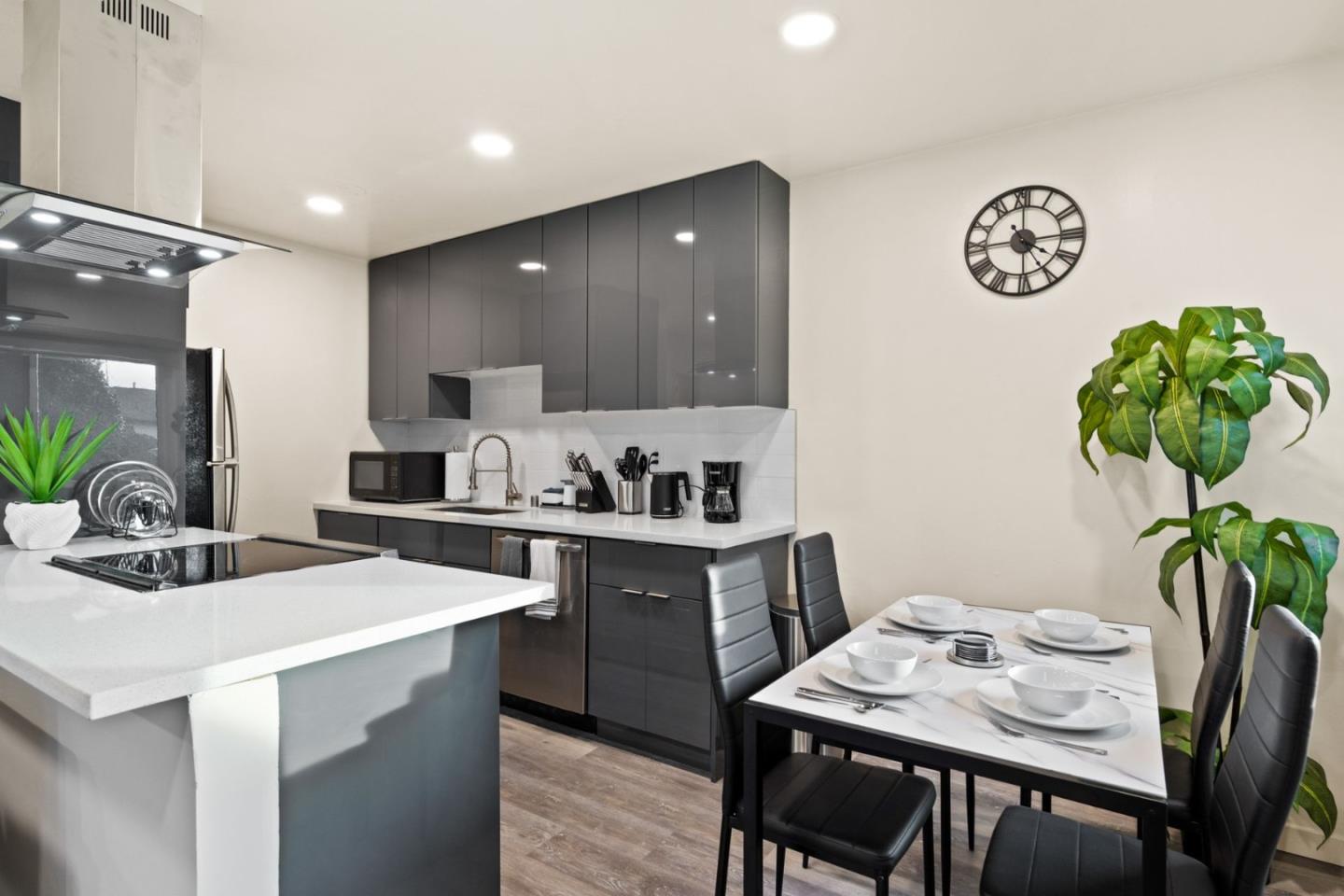 430 Dunster Drive Campbell, CA 95008 - Photo 14 of 31 a kitchen with a table chairs and white cabinets