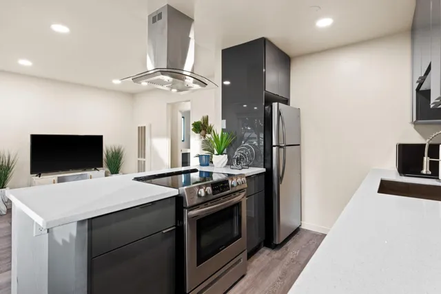 a kitchen that has a microwave a stove and a refrigerator