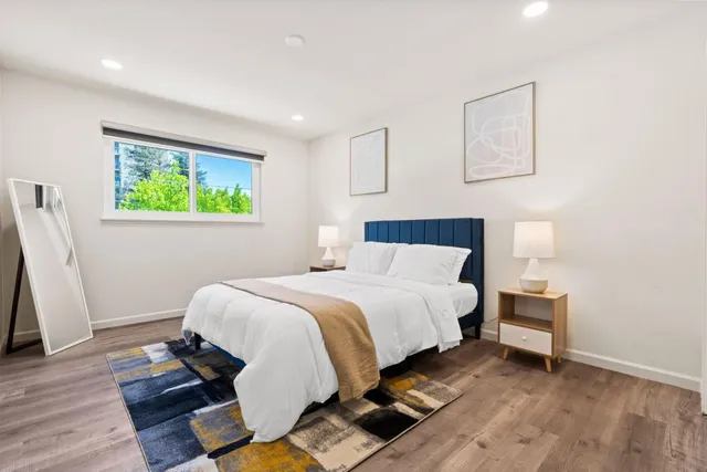 a bedroom with a bed and a window