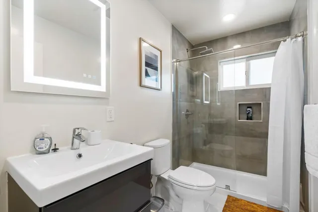 a bathroom with a sink toilet and shower