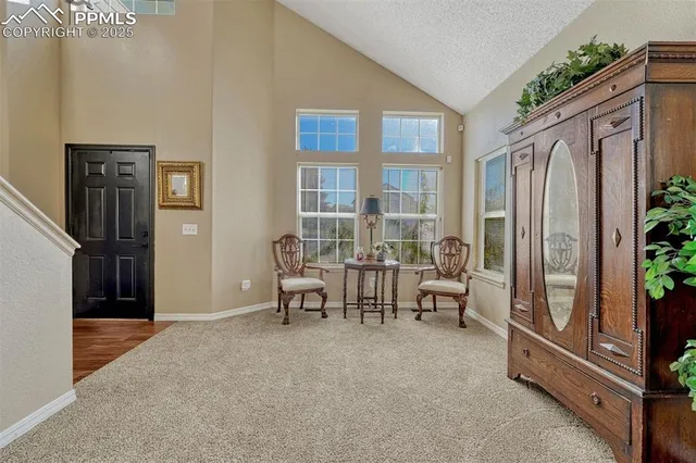 a view of a livingroom with furniture and a window