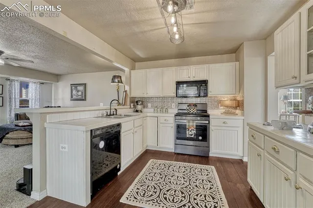 a kitchen with a sink stove and microwave