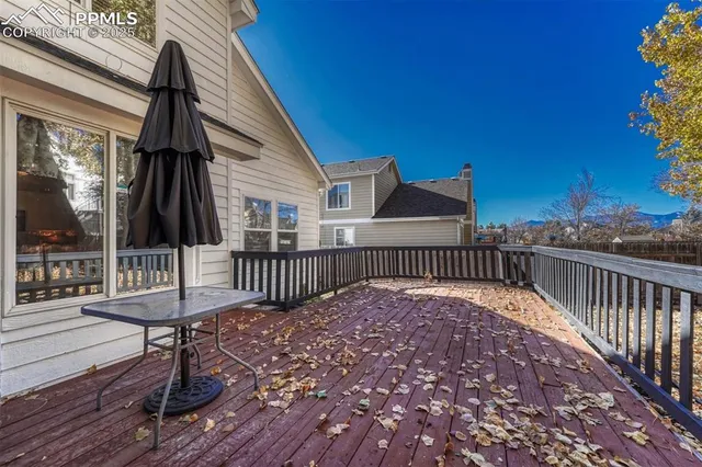a view of a roof deck with couches and wooden floor