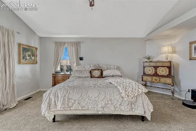 a bedroom with a bed and two night stand