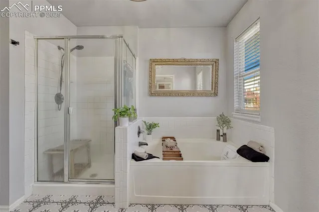 a bathroom with a bathtub and shower