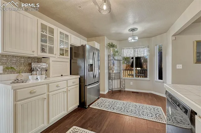 a large bathroom with a granite countertop double vanity sink a mirror and shower