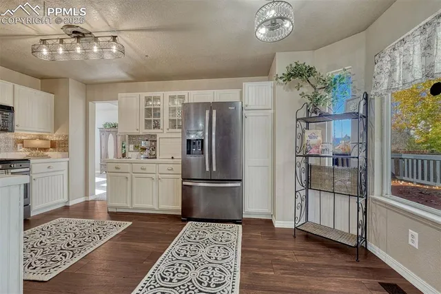 a kitchen with granite countertop stainless steel appliances a counter space and cabinets