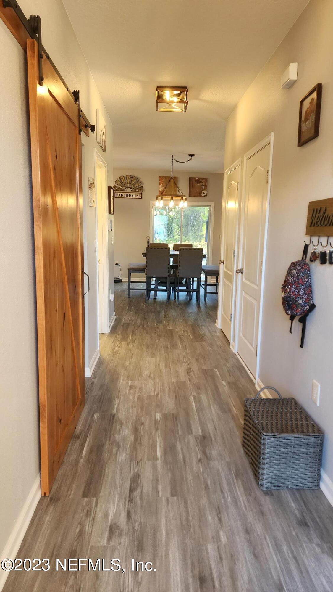 3822 Bronco Road Middleburg, FL 32068 - Photo 3 of 37 a room with wooden floor and furniture