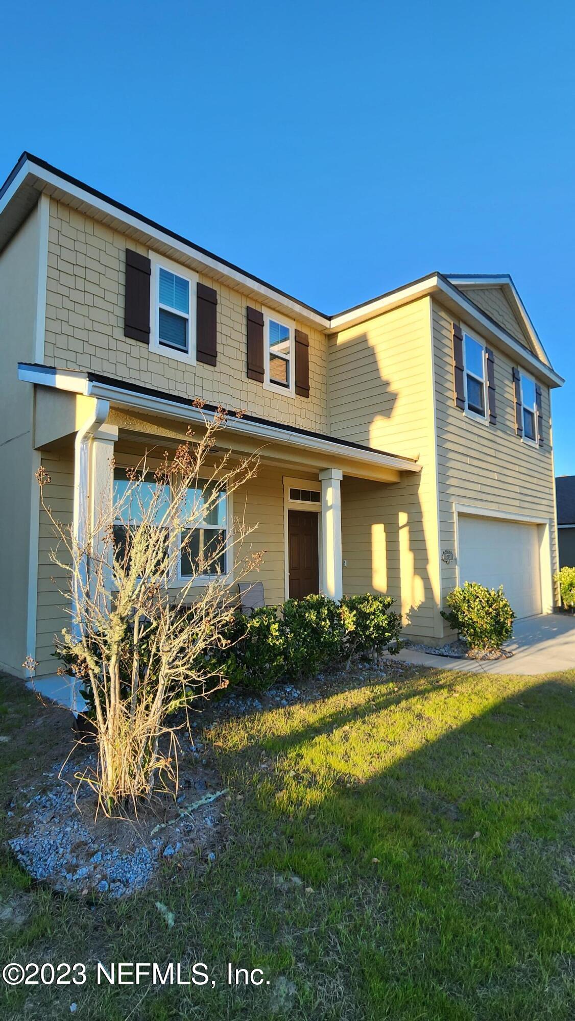 3822 Bronco Road Middleburg, FL 32068 - Photo 32 of 37 a front view of a house with garden