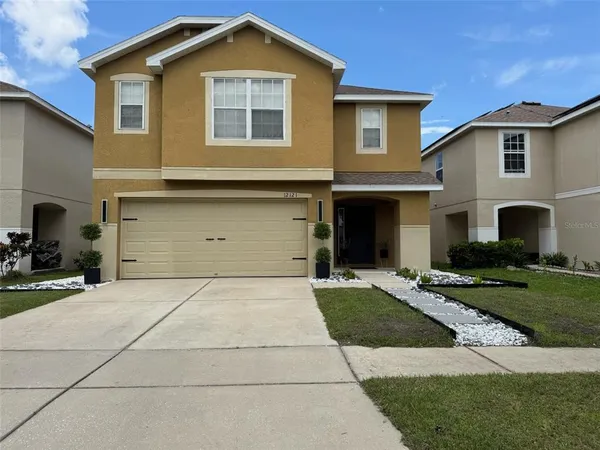 a front view of a house with a yard and garage