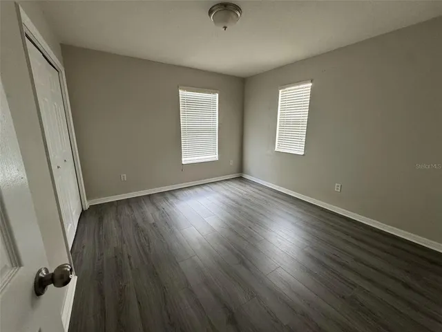 a view of a livingroom with wooden floor and a window