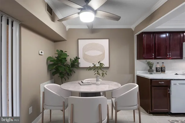 a kitchen with a table and chairs in it