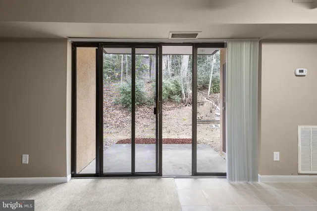 a view of a room that has wooden door