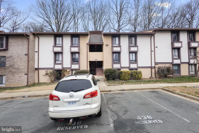 a view of parking area with a car parked