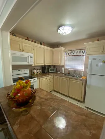 a kitchen with a sink cabinets and window