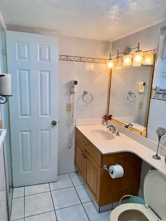a bathroom with a sink mirror and vanity