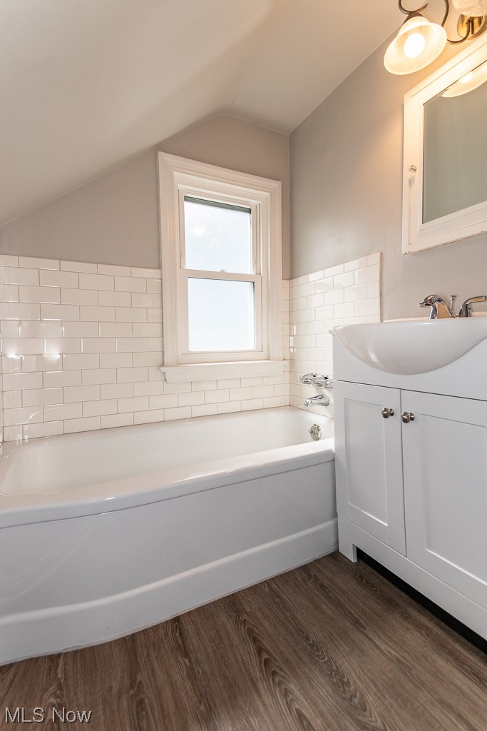 2419 Kingston Road Cleveland, OH 44118 - Photo 27 of 34 2nd floor bathroom featuring lofted ceiling, wood-type flooring, mirror, and vanity