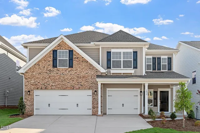 a front view of a house with a garage