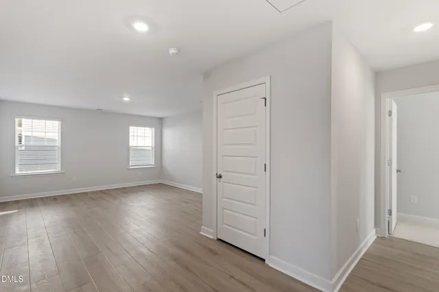 a view of a house with a yard and potted plants