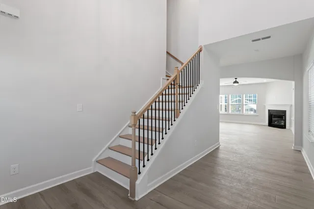a view of an empty room with a fireplace and a window