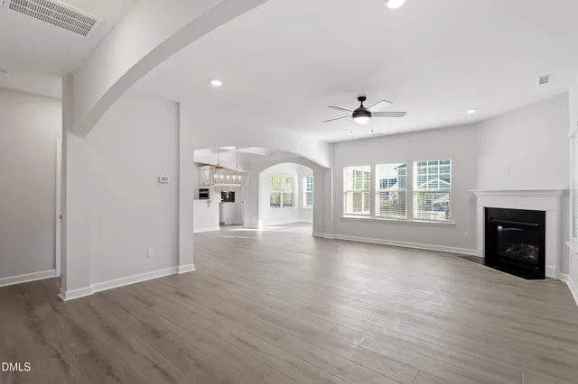 a view of an empty room with a fireplace and a window
