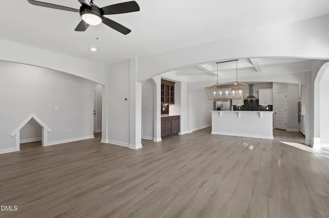 a kitchen with a sink stainless steel appliances and white cabinets