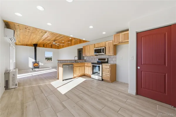 a kitchen with cabinets and wooden floor