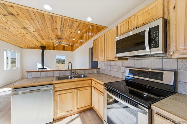 a kitchen with stainless steel appliances a stove sink and cabinets