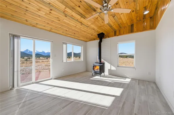 a view of a hallway with wooden floor and a fireplace