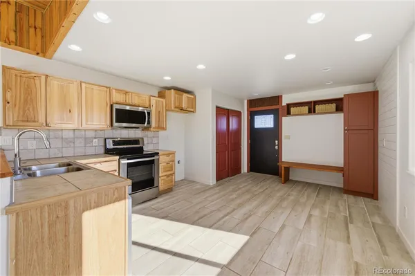 a kitchen with stainless steel appliances a refrigerator stove and sink