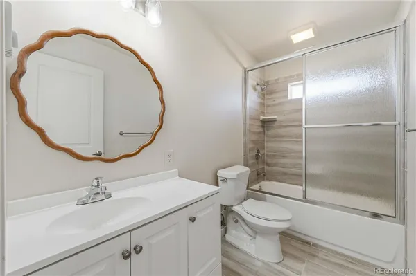 a bathroom with a toilet a sink and a mirror