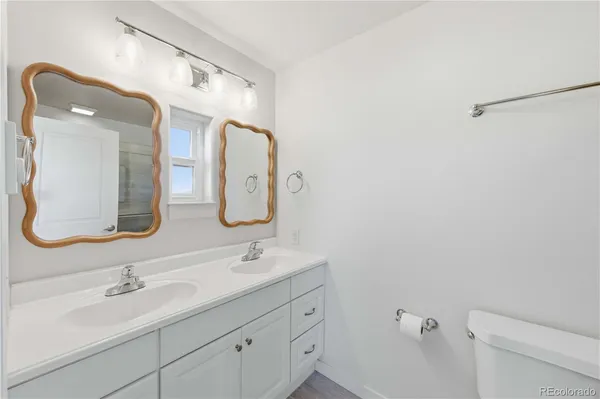 a bathroom with a double vanity sink and a mirror