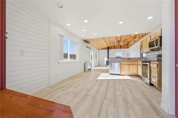 a view of a kitchen with a sink and cabinets