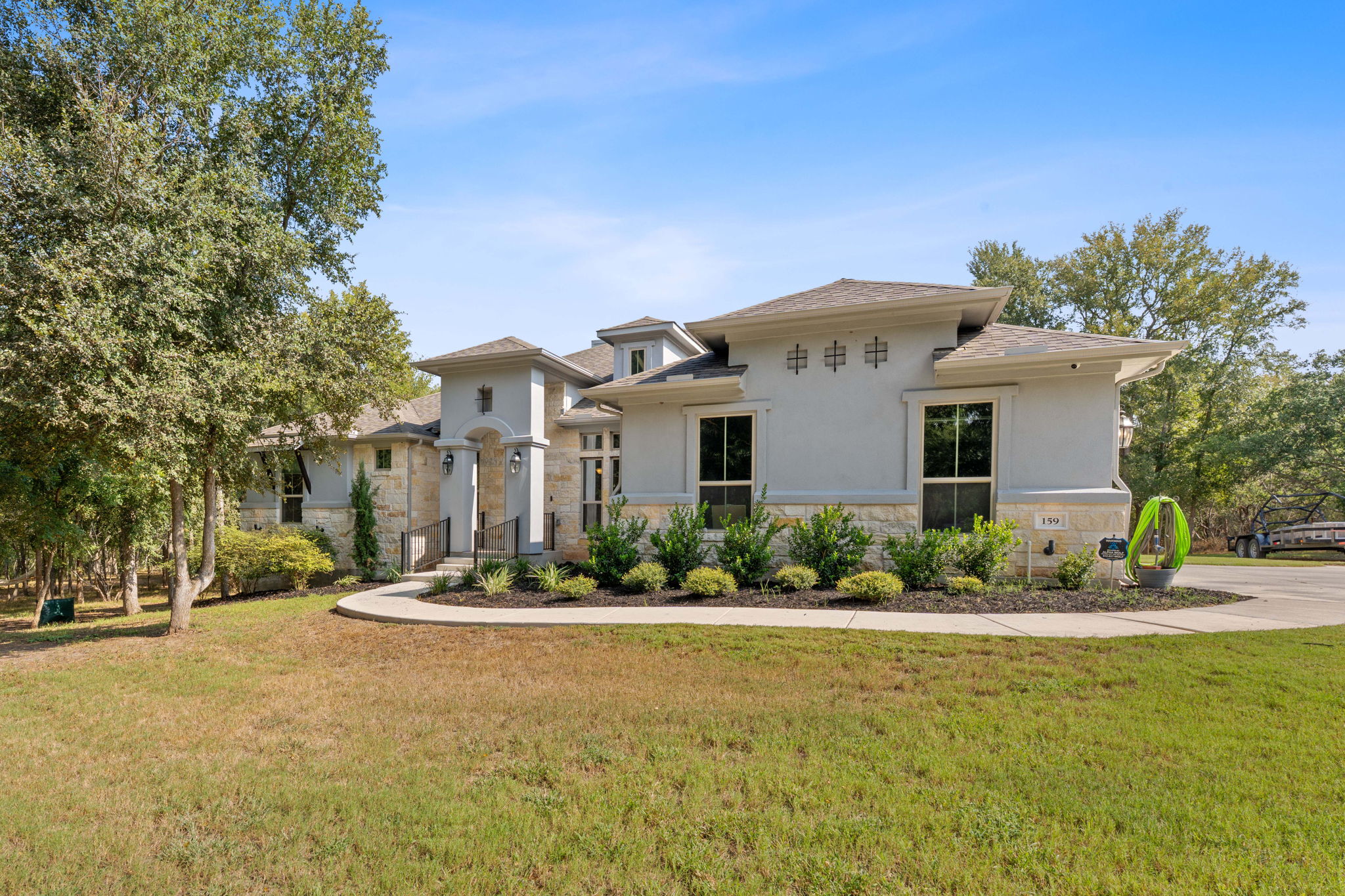 a front view of house with yard and green space