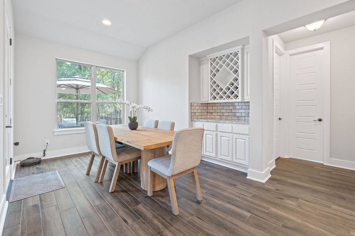 159 Raptor Beak Way Cedar Creek, TX 78612 - Photo 12 of 31 a view of a dining room with furniture window and wooden floor