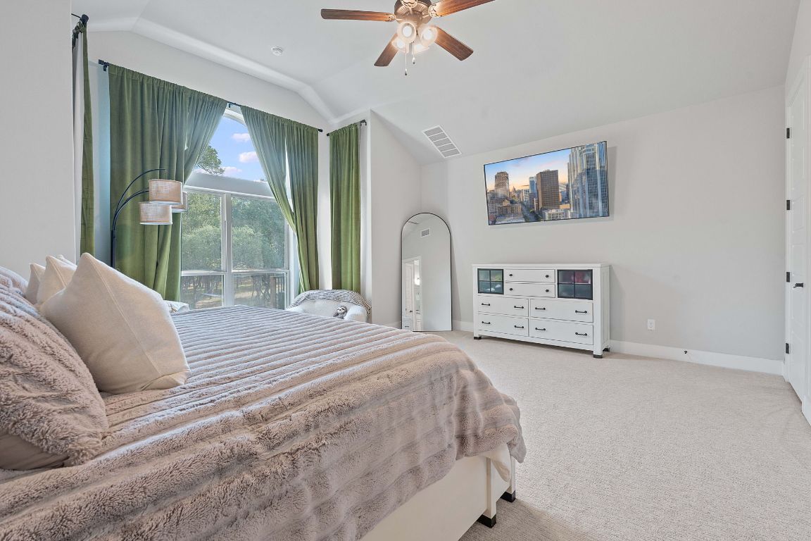 159 Raptor Beak Way Cedar Creek, TX 78612 - Photo 15 of 31 a spacious bedroom with a bed and a large window